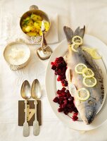 Blue carp with horseradish sauce, beetroot and vegetables in serving dish