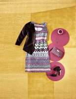 Dress in lilac tones with volant jacket, leather case and heels on yellow background