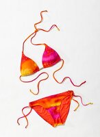 Colourful triangle bikini against white background