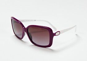 Close-up of purple sunglasses on white background