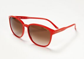 Red sunglasses on white background