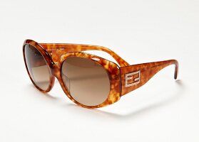 Close-up of brown sunglasses on white background