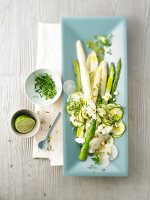 Asparagus salad with feta cheese and herb on serving tray