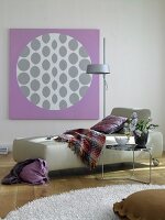 Abstract wall painting on wall with couch swing and side table