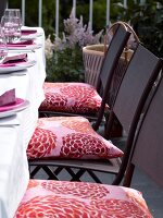 Folding chairs with pink cushion in patio