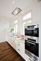 Kitchen in country style with oven, washbasin and drawers