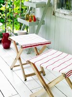 Folding stools covered with tea towels