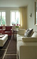Bright living room with red armchair, cushion and sofa