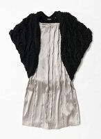 Black knitted bolero over silk dress on white background