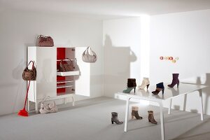 Handbags and boots on cabinet and table