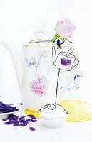 Old china coffee pot used as vase; cupcake and violet bonbons
