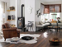 Alpine look; living room with wood-burning stove and corner bench