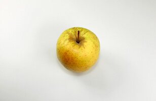 Close-up of golden delicious apple on white background
