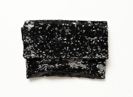 Close-up of black clutch with sequins on white background
