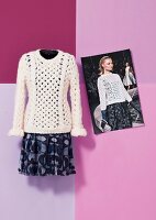 Aran sweater and patterned dress styled by Louis Vuitton with fashion model wearing it
