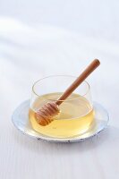 Glass with honey and honey dipper