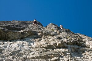 Man climbing on rock mountain at Franconian Switzerland, Bavaria, Germany