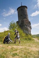 Two knights in front of small tower in Franconian Switzerland, Bavaria, Germany