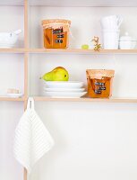 Grapes and pear jelly in jar on the shelf