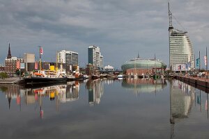 Reflection of harbour and Atlantic Hotel Sail City in sea at Bremerhaven, Bremen, Germany