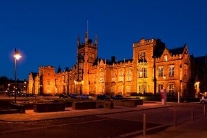 View of illuminated Belfast Queen's University at night, Belfast, Ireland, UK