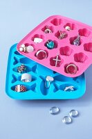 Jewellery stored in pink and blue ice cube trays
