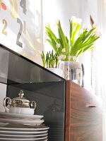 Dishes behind glass door of sideboard