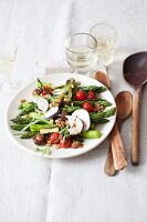 Warm asparagus salad with goat cheese on plate