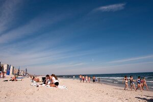 People relaxing on beach, New York, USA