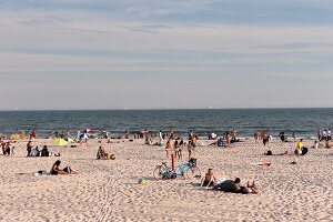 People relaxing on beach, New York, USA