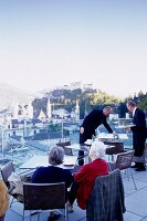 People looking at cityscape from the tower of Modern Museum, Salzburg, Austria