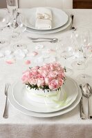 Wedding table place setting with pink flowers