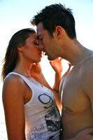 Passionate couple holding each other and kissing on beach