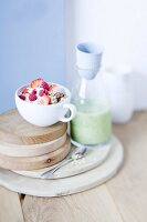 Muesli with honey berries and yogurt and a bottles of cucumber shake