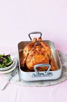 Spicy roast chicken in a roasting tin