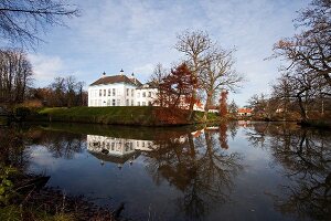 Reflection of white mansion facade in water, Gelting , Germany