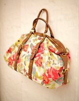 Close-up of floral print canvas bag with leather straps