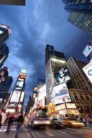 Low angle view of illuminated advertisements on building at Times Square in New York, USA
