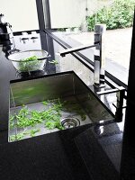 Bowl of salad kept aside after being washed in sink