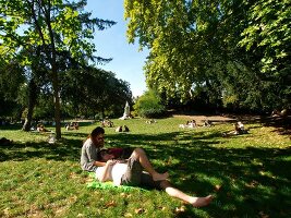 Couples relaxing in Parc Monceau in Paris, France