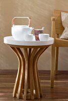 White tray on table with teapot and cups