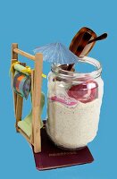 Beach chair, glass jar with sand, ornamental umbrella and sunglasses on white background