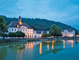 View of illuminated Landgrave Carl-channel at dusk in Bad Karlshafen, Hesse, Germany