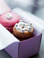 Close-up of macaroons with frosting and beads in box