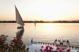 People in felucca on Nile at dusk, Luxor, Egypt