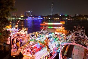 View of people in illuminated boat on Nile river, Cairo, Egypt