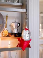 Close-up of espresso pot and wooden spoon on shelf with chef jacket key ring