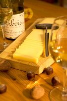 Cheese slice with cheese tester on wooden board in Fort de Saint at Franche-Comte, Antoine