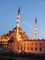 Illuminated Yeni Mosque at dusk in Istanbul, Turkey