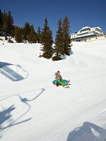People having fun on snow tubing at Truebsee, Titlis, Uri Alps, Engelberg, Switzerland